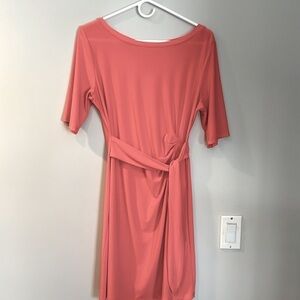 Poly spandex blend peach dress with wrap detail. No tags.